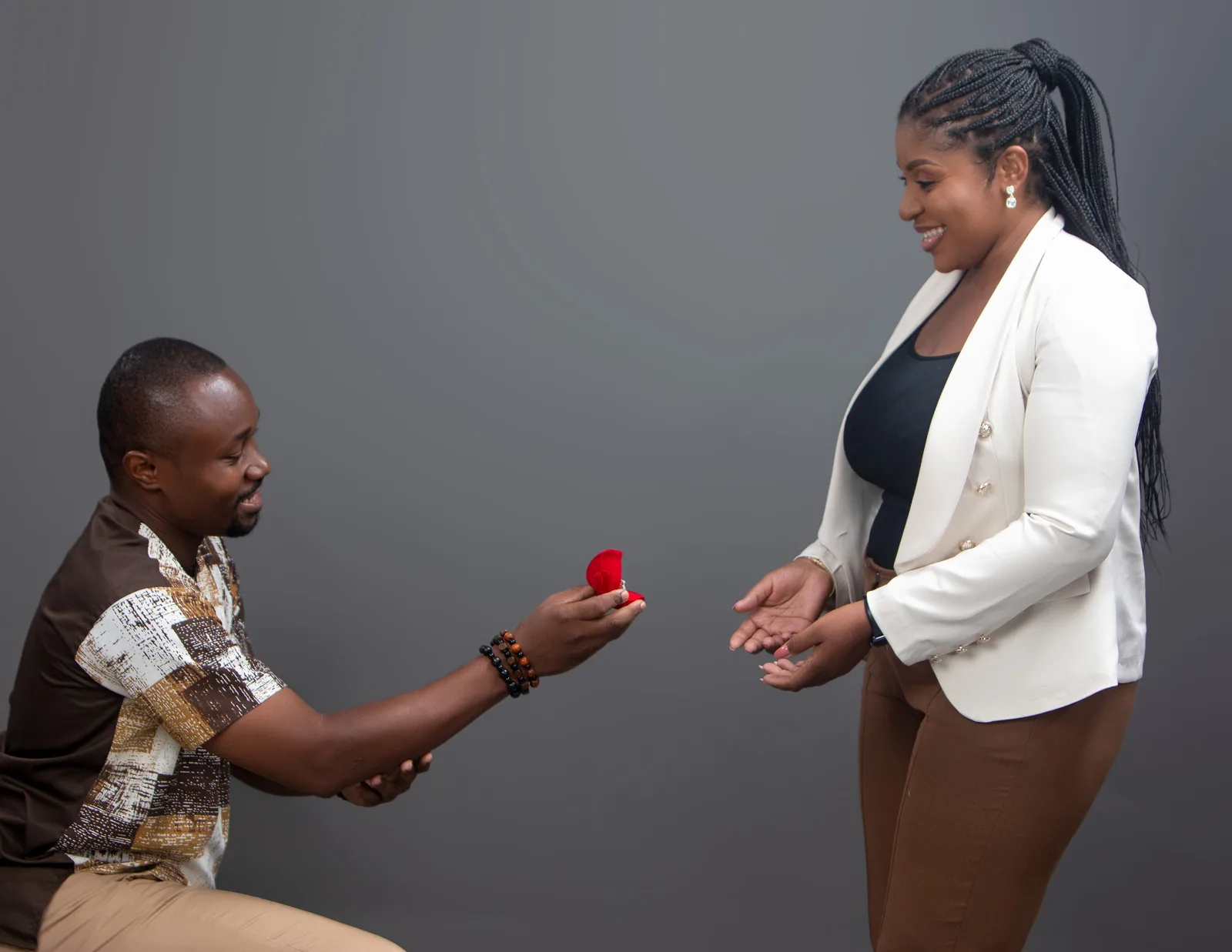 Clardad kneeling with a red ring box
